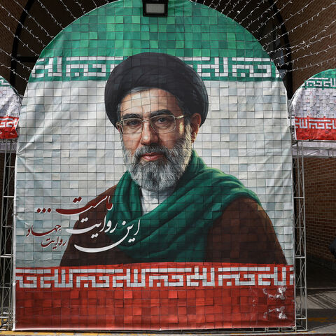 FILE PHOTO: A woman walks next to a banner with a picture of Iran's new Supreme Leader Mojtaba Khamenei in Tehran, Iran, May 8, 2026. Majid Asgaripour/WANA (West Asia News Agency) via REUTERS