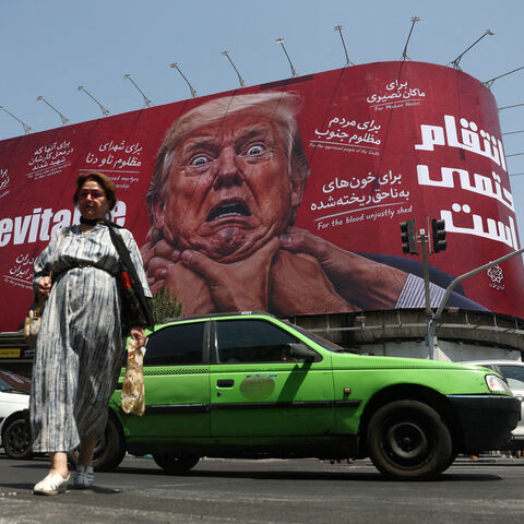 A woman walks near a billboard depicting U.S. President Donald Trump on a building in Tehran, Iran, July 27, 2026. Majid Asgaripour/WANA (West Asia News Agency) via REUTERS