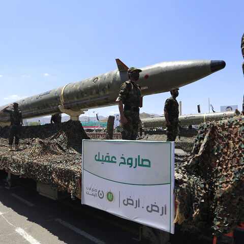 Houthi soldiers stand guard on a missile carrier during an official military parade marking the ninth anniversary of the Houthi takeover of the capital, Sanaa, on Sept. 21, 2023.