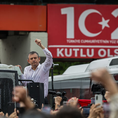 Turkey’s main opposition Republican People's Party's (CHP) Ousted party leader Ozgur Ozel waves to supporters from atop a police water cannon vehicle after being forcibly evicted by police from his party’s headquarters on May 24, 2026 in Ankara, Turkey.