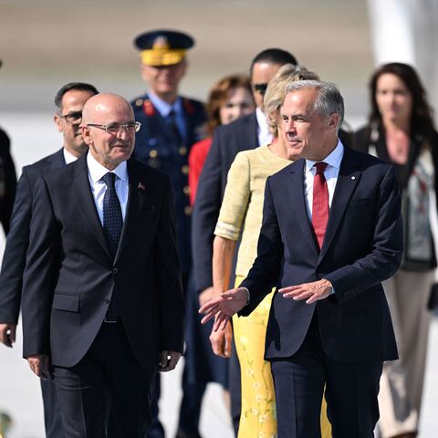 Canada's Prime Minister Mark Carney (R) is welcomed by Turkey's Treasury and Finance Minister Mehmet Simsek upon arrival at Esenboga Airport to attend the 36th NATO Heads of State and Government Summit in Ankara on July 7, 2026. (Photo by Muhammed Abdullah Kurtar / POOL / AFP via Getty Images)