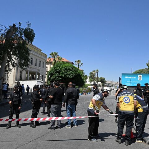 Security personnel and first responders prepare to cordon off an area near the Four Seasons Hotel following two blasts nearby in Damascus on July 7, 2026. Syrian authorities said 18 people were wounded by two blasts in central Damascus on July 7 near the hotel where France's president spent the night, with the Elysee Palace saying his visit is ongoing. (Photo by LOUAI BESHARA / AFP via Getty Images)