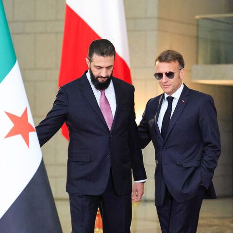 Syrian President Ahmed al-Sharaa (L) welcomes France's President Emmanuel Macron for a joint press conference in Damascus on July 7, 2026. 