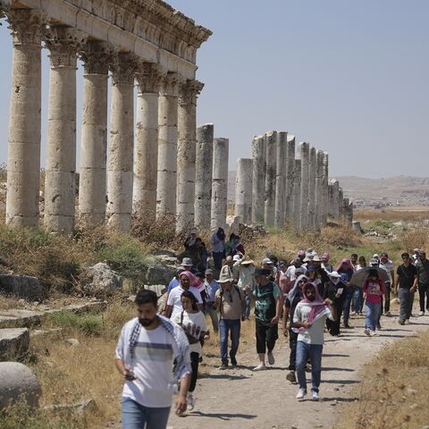 Tourism students and visitors visit the ruins of the ancient city of Apamea in the Hama countryside, Syria, on July 8, 2026. 