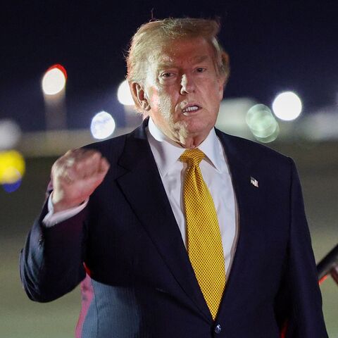 US President Donald Trump gestures as he steps off Air Force One to board the new Qatari-gifted Boeing plane, en route to the United States following his participation in the NATO Summit at Royal Air Force Mildenhall on July 8, 2026, in Mildenhall, England. 