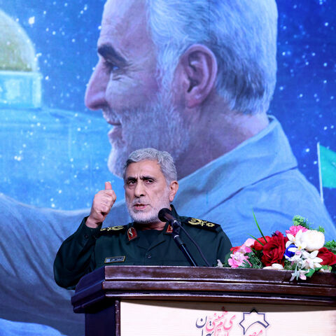 The commander of the Quds Force of the Islamic Revolutionary Guard Corps, Esmail Qaani, speaks during a commemoration ceremony marking the anniversary of the 2020 killing of Guards general Qasem Soleimani (on screen) in the capital Tehran on Jan. 3, 2024. 