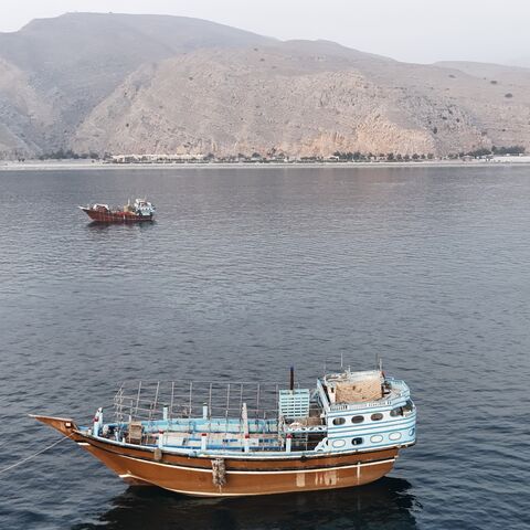 This aerial photograph shows boats anchored off Oman's northern Musandam Peninsula near the Strait of Hormuz on June 27, 2026. 