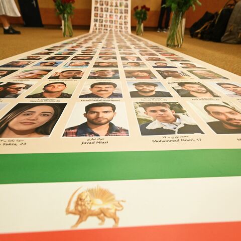 This photograph shows a banner featuring photos of Iranian protesters allegedly killed by the regime during a demonstration at the Ergife Palace Hotel to condemn the silence of Western governments in the face of the growing wave of Iranian political executions, in Rome, on July 16, 2026. 
