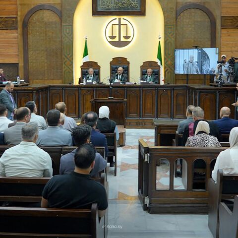 This handout picture released by the official Syrian Arab News Agency on Aug. 18, 2026, shows Judge Fakhr al-Din al-Aryan (C) during the sentencing of Wassim al-Assad.