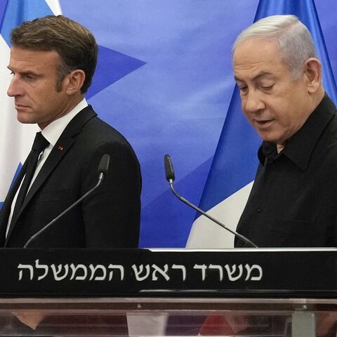 Israeli Prime Minister Benjamin Netanyahu and French President Emmanuel Macron arrive to hold a joint press conference in Jerusalem, Oct. 24, 2023.