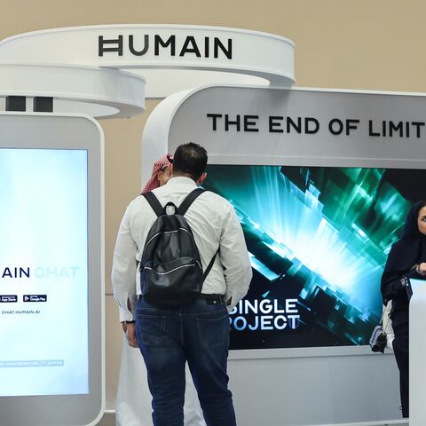 Guests stand at the booth of Saudi artificial intelligence company Humain during the Future Investment Initiative (FII) conference in Riyadh, on Oct. 29, 2025. 