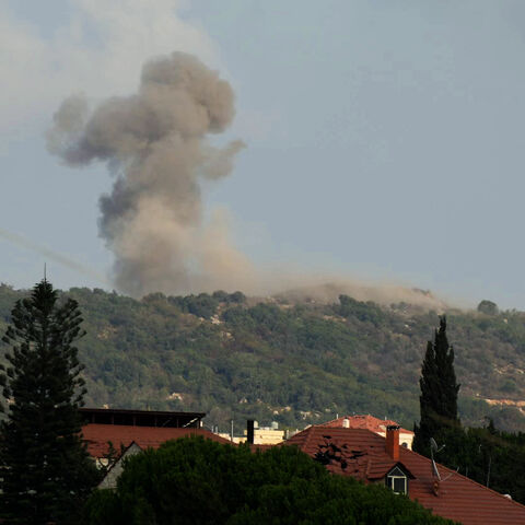 A photograph taken from the southern Lebanese area of Nabatieh shows smoke as it rises from the site of Israeli strikes that targeted the hilltops of the mountainous area of the strategic Ali al-Taher Ridge on Aug. 14, 2026.  