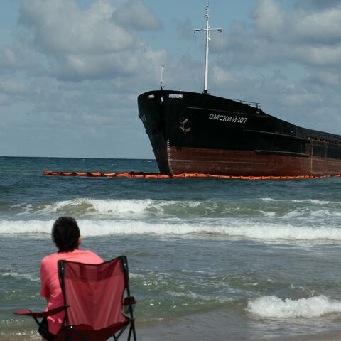 People swim next to the Russian-flagged cargo ship OMSKIY-107, which was attacked off the Black Sea coast and eventually ran aground off the shore of the Sile district, Istanbul, Sept. 3, 2026.