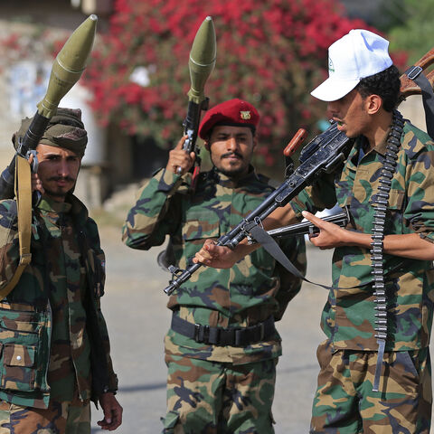 Fighters loyal to the Houthi authorities, brandish their weapons during a rally to recruit more fighters, in Sanaa on September 10, 2026. The country relapsed into war in July after years of calm, drawn into the regional conflict triggered by the US-Israeli offensive against Iran that began at the end of February. (Photo by Mohammed HUWAIS / AFP via Getty Images)