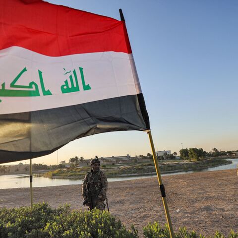 Members of Iraq's Hashed al-Shaabi (Popular Mobilization) paramilitary forces stand guard during an election rally for the "Asaib Ahl al-Haq" movement in the capital Baghdad, on October 7, 2021. 