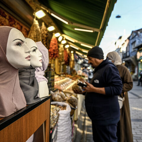 A shop owner assists one of his customers at Malta bazaar in the Fatih district in Istanbul, on Dec. 6, 2024.