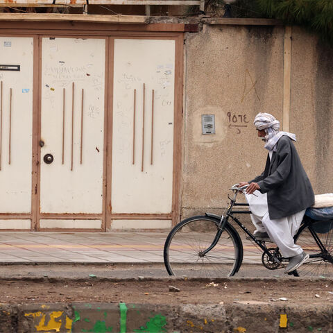 A Baluch Iranian man rides a bicycle in Zahedan, in the southeastern province of Sistan-Baluchistan bordering Afghanistan on Dec. 18, 2025, during a media tour organized by the Iranian government. 
