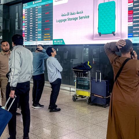 Travelers consult the departures screens at the terminal at King Khalid International Airport in Riyadh, on March 10, 2026.