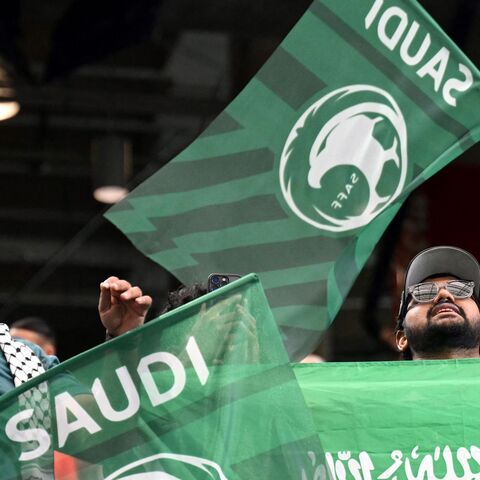 Saudi Arabia football supporters wave flags