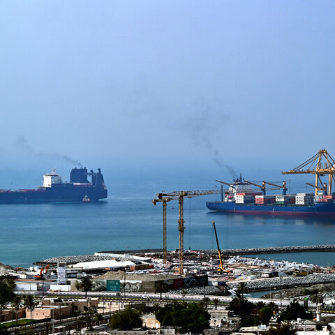 Ships are docked along a pier at the Khor Fakkan Container Terminal, the only natural deep-sea port in the region and one of the major container ports in Sharjah Emirate, along the Gulf of Oman on July 14, 2026.