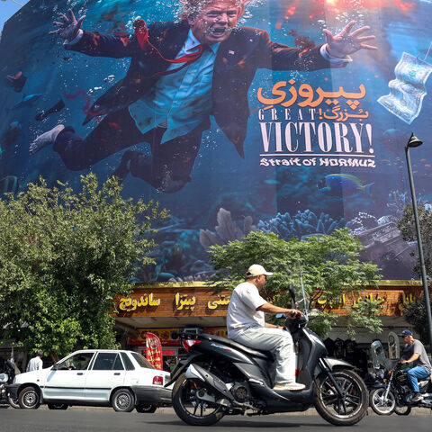 Motorists drive past an anti-US billboard in Tehran on Aug. 24, 2026.
