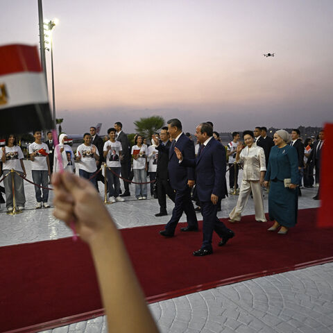 China's President Xi Jinping (center L) walks along with his Egyptian counterpart Abdel Fattah al-Sisi followed by their wives Peng Liyuan and Entissar Amer (R) upon their arrival at the Cairo International Airport on September 1, 2026. President Xi Jinping arrived in Egypt on September 1, making a rare trip to the Middle East as both countries face the threat of US sanctions over financial links to Iran. (Photo by Khaled DESOUKI / POOL / AFP via Getty Images)