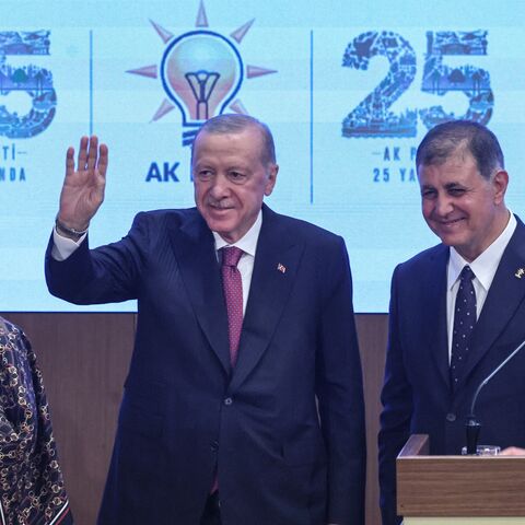 Izmir Mayor Cemil Tugay (R) his wife Oznur Tugay and Turkish President Recep Tayyip Erdogan acknowledge the audience after the mayor announced joining the ruling Justice and Development Party during a meeting with AKP lawmakers in Ankara, on Oct. 7, 2026. 