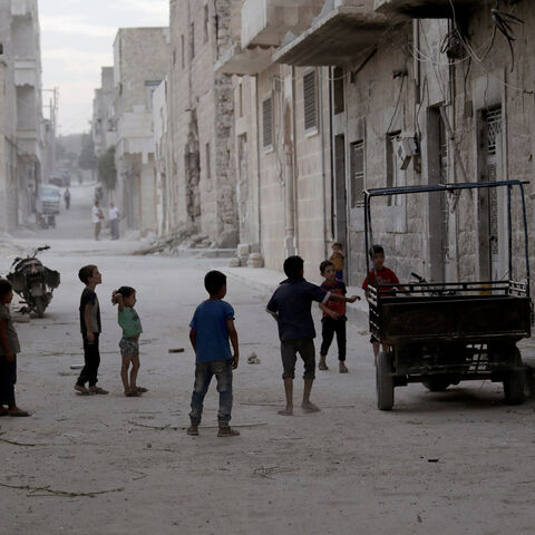 Children play along a street on the southern outskirts of the Syrian city of al-Bab, Syria September 16, 2017. Picture taken September 16, 2017. REUTERS/Khalil Ashawi - RC1E136FE550