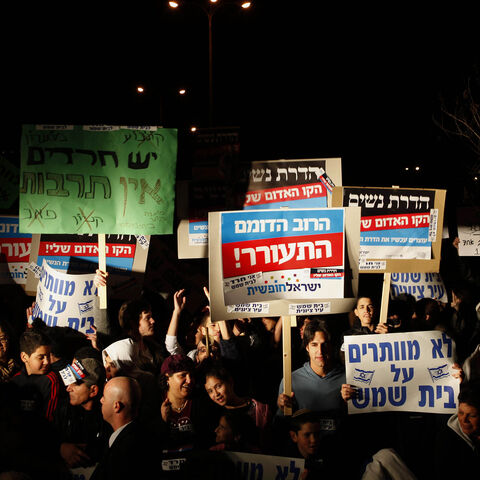 Israelis protest against gender segregation and violence towards women by ultra Orthodox Jewish extremists on December 27, 2011 in the town of Beit Shemesh, near Jerusalem. The protest comes after a wave of incidents in Israel in which women have been compelled to sit at the back of segregated buses serving ultra-Orthodox areas or get off, despite court rulings that women may sit where they please. AFP PHOTO/GALI TIBBON (Photo credit should read GALI TIBBON/AFP/Getty Images)
