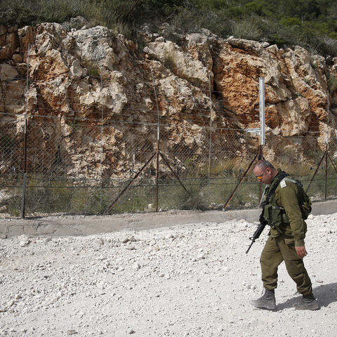 An Israeli soldier walks near the area where the Israeli army is excavating part of a cliff to create an additional barrier along its border with Lebanon, near the community of Shlomi in northern Israel April 6, 2016. Israeli Defence Forces (IDF) Lieutenant-General Eli David, who serves as an engineering officer in a northern division, told Reuters on Wednesday that the army began work on the new barrier by exposing the cliff in January 2015, to help protect communities located close to the Lebanese border 