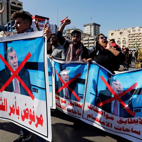 Iraqi demonstrators and university students carry posters depicting the newly appointed Prime Minister of Iraq, Mohammed Tawfiq Allawi, to express their rejection of him, during ongoing anti-government protests in Baghdad, Iraq February 2, 2020. REUTERS/Wissm al-Okili - RC2CSE9SET8I