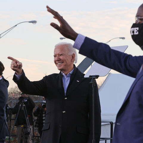 ATLANTA, GEORGIA - JANUARY 04: President-elect Joe Biden (C) rallys with Democratic candidates for the U.S. Senate Jon Ossoff (L) and Rev. Raphael Warnock (R) the day before their runoff election in the parking lot of Center Parc Stadium January 04, 2021 in Atlanta, Georgia. Biden's trip comes a day after the release of a recording of an hourlong call where President Donald Trump seems to pressure Georgia Secretary of State Brad Raffensperger to “find” the votes he would need to reverse the presidential ele