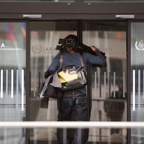A cameraman arrives at the International Atomic Energy Agency (IAEA),prior to a press conference at the agency's headquarters in Vienna on March 4, 2021. - European nations will not go ahead with a planned resolution criticising Iran at this week's meeting of the UN nuclear watchdog, diplomatic sources said on March 4, 2021. (Photo by ALEX HALADA / AFP) (Photo by ALEX HALADA/AFP via Getty Images)