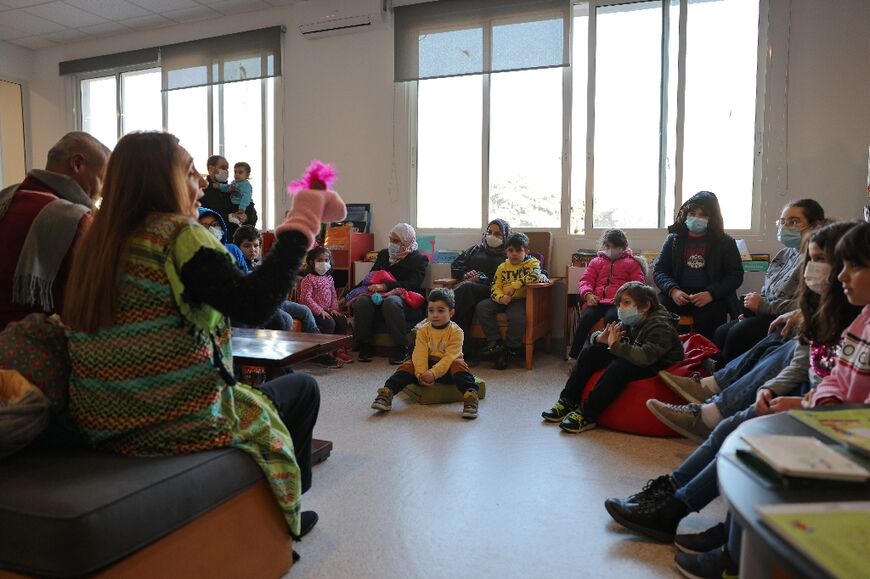 Children listen to storytellers at one of Beirut's public libraries, which have grown popular as an economic crisis has placed many books out of financial reach