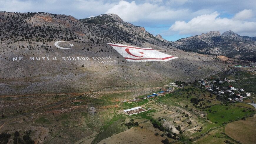 The flag of the self-proclaimed Turkish Republic of Northern Cyprus painted on the Kyrenia mountain range north of the divided Cypriot capital Nicosia