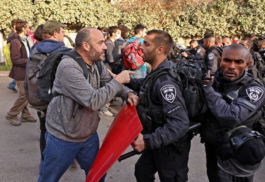 A protester argues with an Israeli policeman in Sheikh Jarrah 