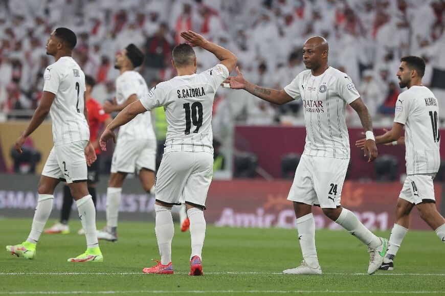 Santi Cazorla, number 19,  one of Al Sadd's star imports, celebrates a goal with team-mates