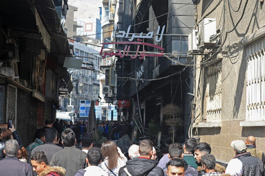 Crowds gathered to see the damage despite appeals by fire fighters, with many business owners distraught at losing their livelihoods