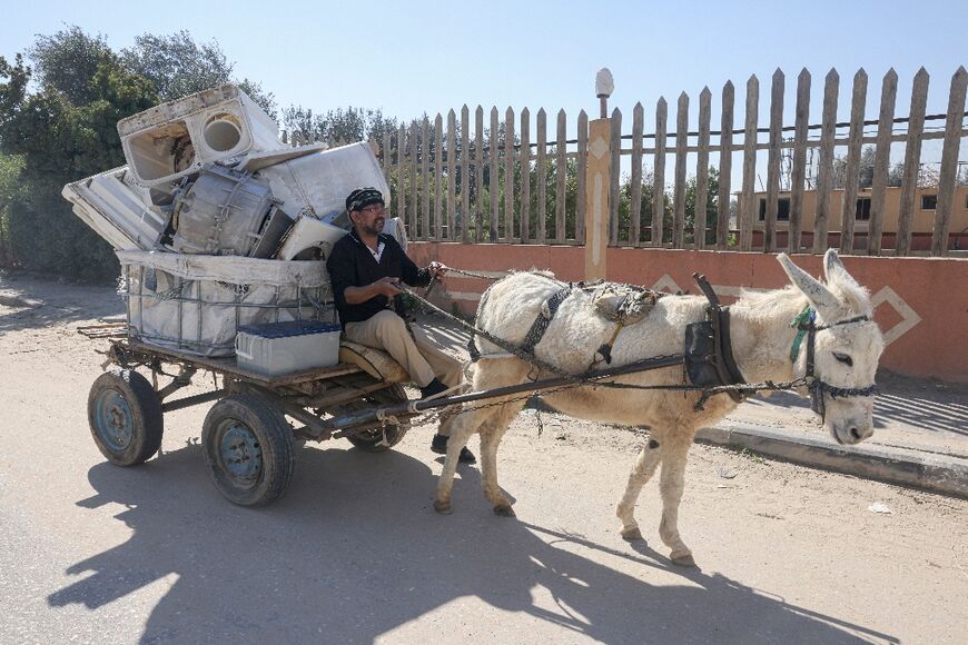 A Palestinian man collects discarded batteries for recycling in Gaza; battery collection is also a source of income for the impoverished territory, where unemployment rates hover around 50 percent