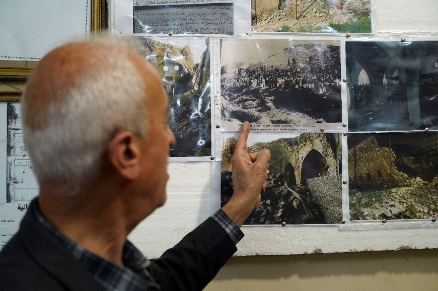 Joseph Elias Yalda, of the Al-Qosh heritage museum, points to old photographs depicting the Prophet Nahum Synagogue