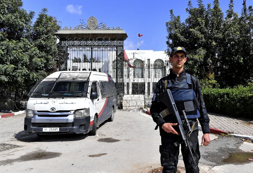 A Tunisian officer stands guard outside parliament in Tunis on March 31