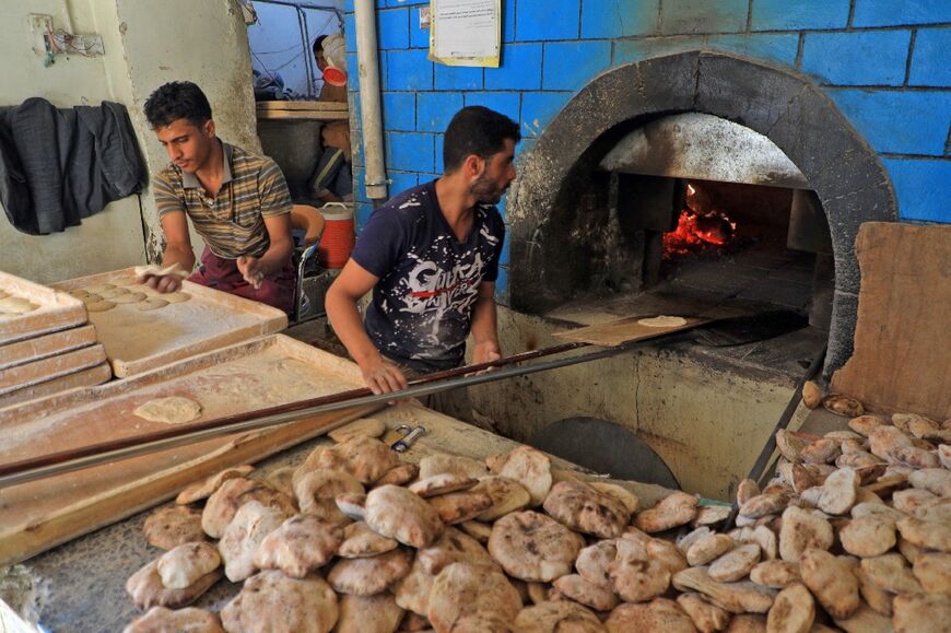 Workers prepare bread at a bakery in the war-torn Yemeni capital Sanaa