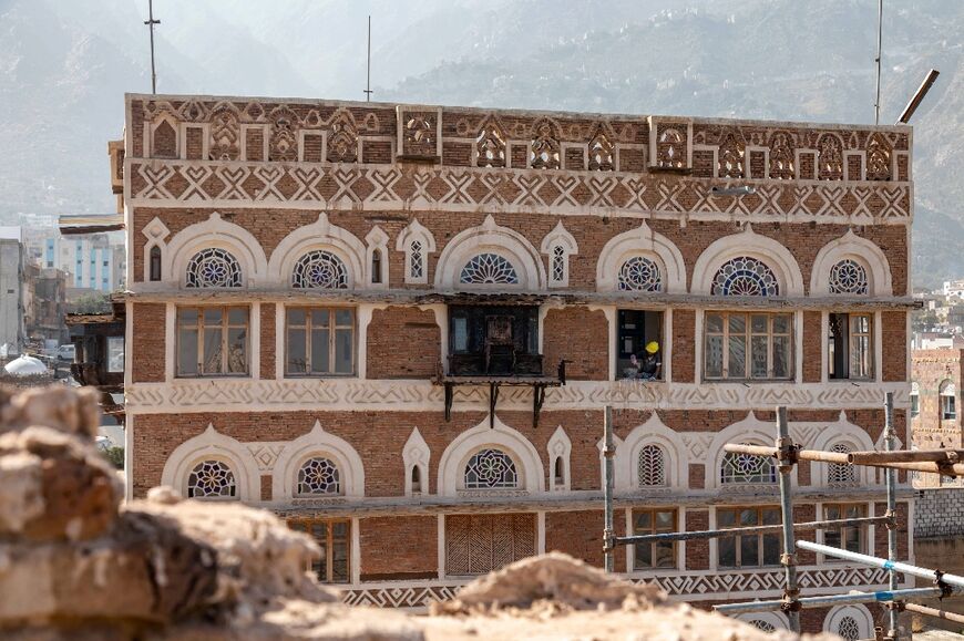 Workers repair the war-damaged National Museum complex in Yemen's third city of Taez