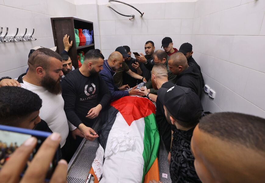 Palestinian mourners surround the body of Sanad Abu Atiyeh at a hospital in the town of Jenin on March 31, 2022