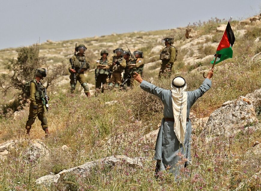 Members of Israeli security forces deploy as Palestinians demonstrate against the establishment of Israeli outposts on their lands, in Beit Dajan east of Nablus in the occupied West Bank