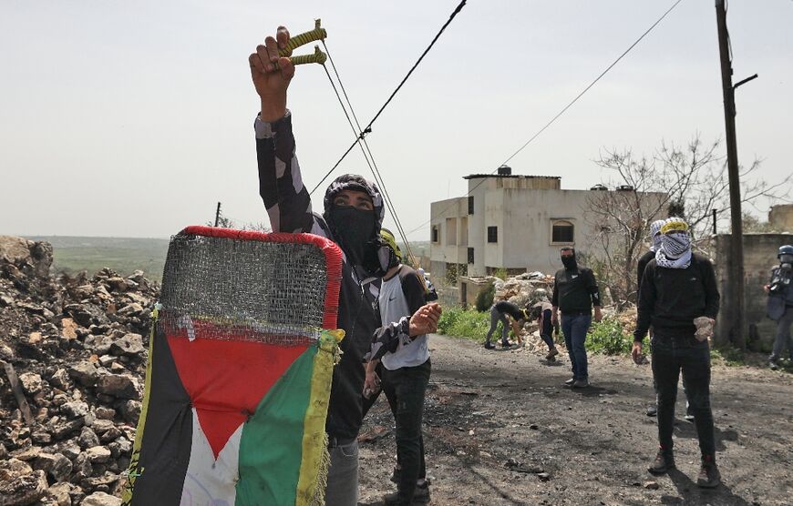 Palestinians demonstrating against the expropriation of land by Israel, clash with Israeli security forces in the village of Kfar Qaddum near the Jewish settlement of Kedumim in the occupied West Bank, on April 1