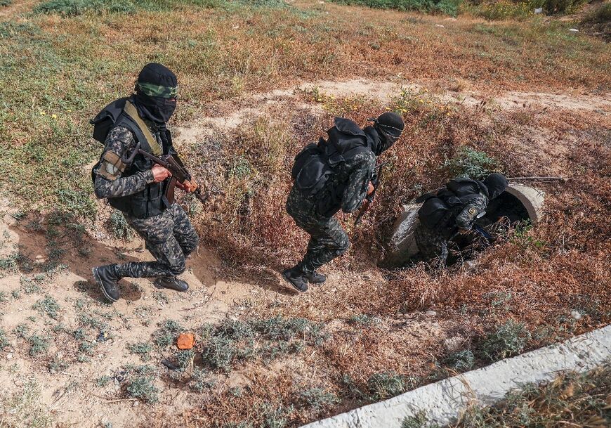 The Gaza Strip is run by Hamas, but it is also home to the Islamic Jihad militant group, whose personnel are pictured entering a tunnel in the Palestinian enclave on Sunday