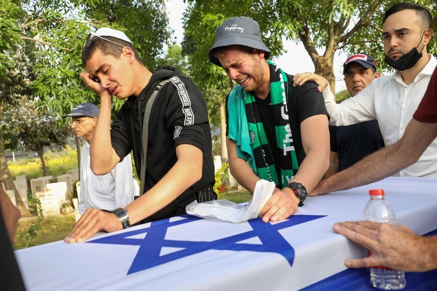 Relatives and friends mourn during the funeral of Israeli Eytam Magini in the central Israeli city of Kfar Saba, on April 10, 2022