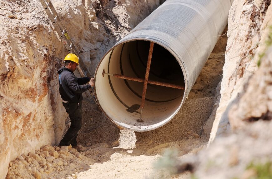 A man works on the construction of a new pipeline by Israel's national water company near kibbutz Ravid, west of Sea of Galilee