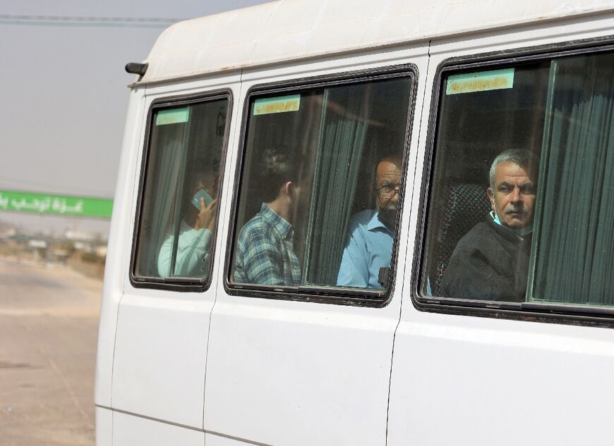 Palestinian workers leave Beit Hanun in the northern Gaza Strip to reach Israel through the Erez crossing following its reopening on April 26, 2022